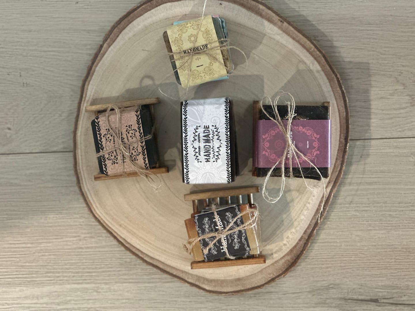 Exfoliating Moisture Bar Soaps beautifully wrapped and tied with twine, arranged on a wooden platter for a natural, elegant touch.