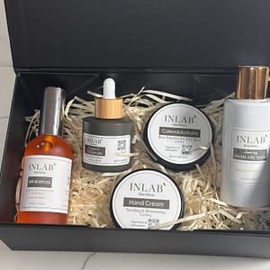 A luxurious Gift Box #2 containing various skincare products: serums and creams, nestled in straw, all labeled with "INLAB