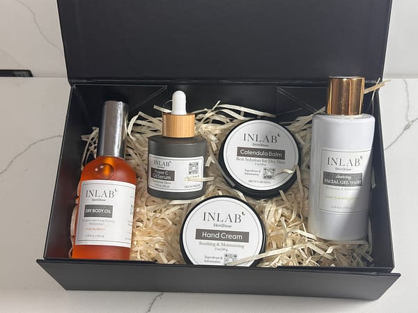 A luxurious Gift Box #2 containing various skincare products: serums and creams, nestled in straw, all labeled with "INLAB